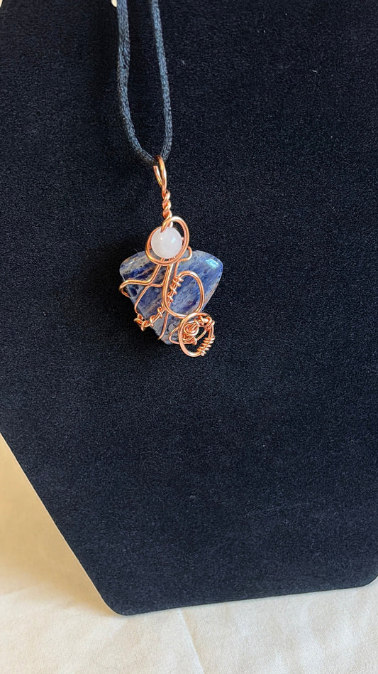 Blue-and-white sodalite pendant with rose quartz bead and copper wire wrapping